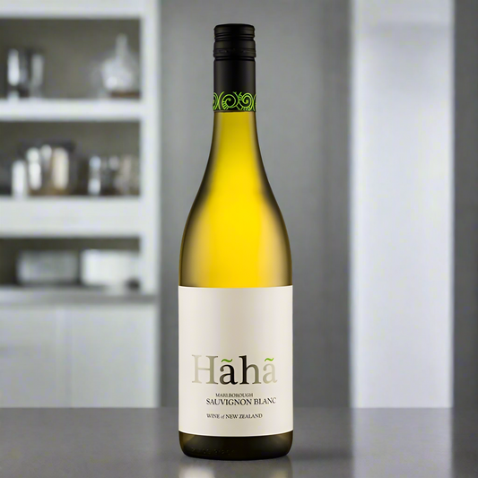 Wine bottle with 'Haha' label on a white background. Its sat on a kitchen top