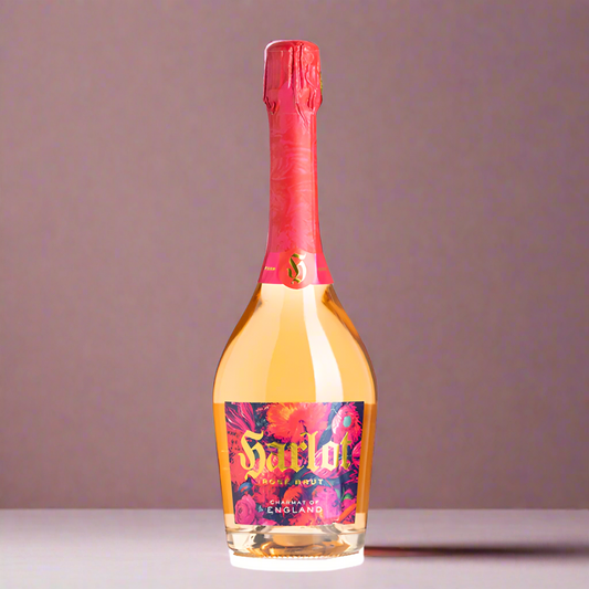 Bottle of Harlot Rosé against a dusky pink background. The label is bright with flowers