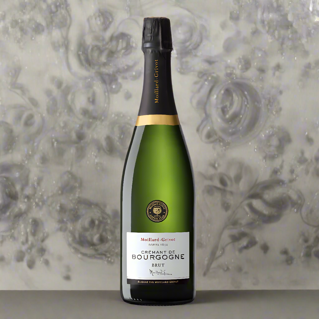 A bottle of cremant with a white label set against a grey floral wall paper
