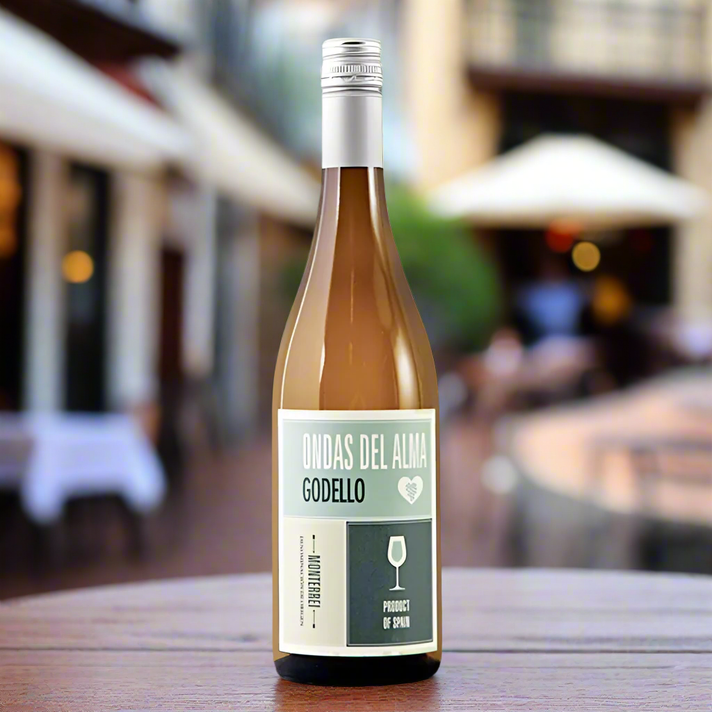 Wine bottle labeled 'Ondas Del Alma Godello' sat on a table outside a restaurant