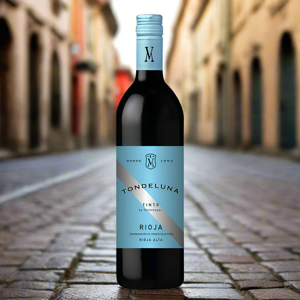 Wine bottle with blue label sat on a cobbled street