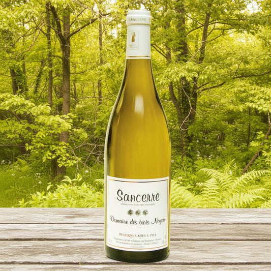 Bottle of Sancerre wine on a wooden table with a forest background