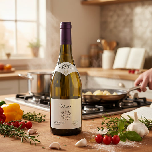 Bottle of white wine on a kitchen top where food is being prepared