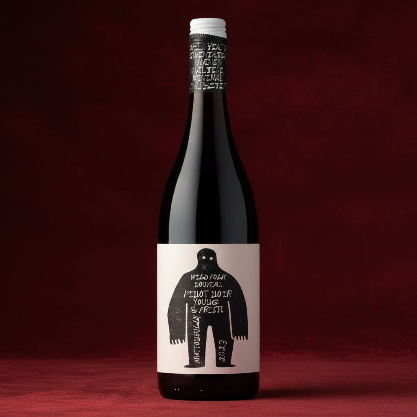 A bottle of red wine with a white label featuring a black silhouette of a person and handwritten-style text, set against a plain white background.