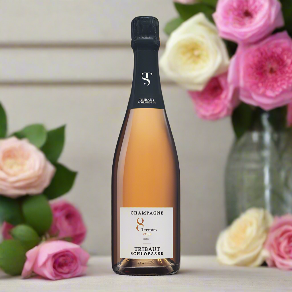 Bottle of Tribaut champagne with flowers in the background